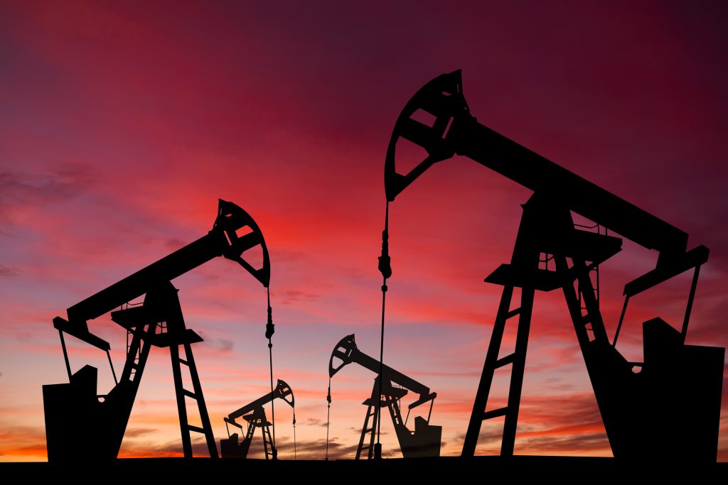 Oil pump on a sunset background. World Oil Industry