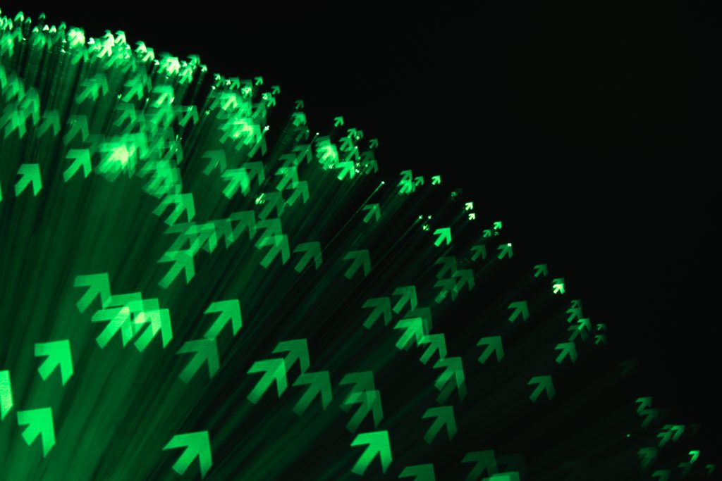 Stock_Green Colored Up Arrows Made of Fiber Optic Lights in Fan Shape.